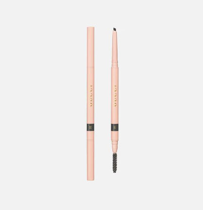 Pink eyebrow pencil with black tip on a light gray background