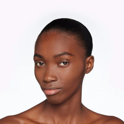 Woman with a neutral expression on a white background