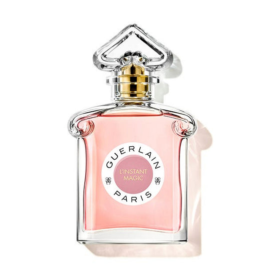 Guerlain perfume bottle with pink glass and gold cap on a white background