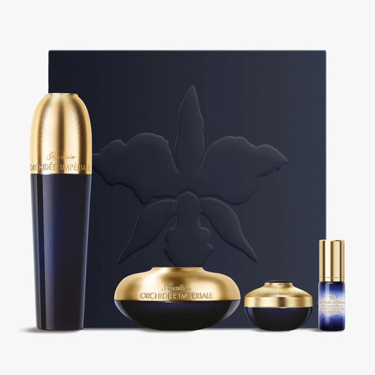 Set of luxury cosmetic products with gold and black design on a white background