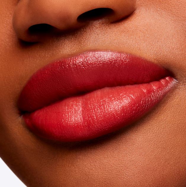 Close-up of a person's lips wearing a bold red lipstick.