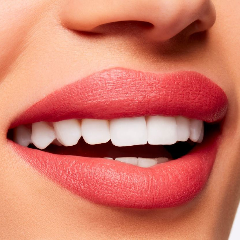Close-up of a person's lips with red lipstick