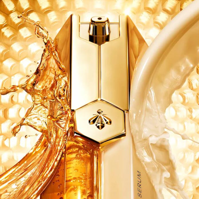 Gold cosmetic bottle with honeycomb background