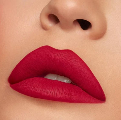 Close-up of a person wearing bright red lipstick on a neutral background