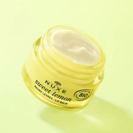 Nuxe sweet lemon lip balm jar on a light green background