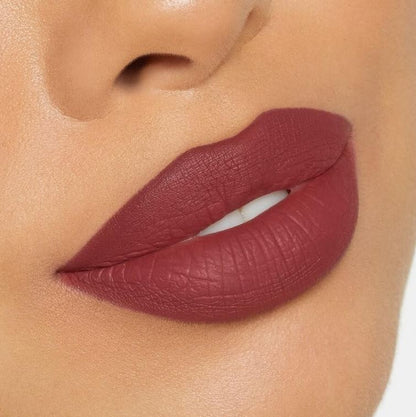 Close-up of a person wearing a deep red lipstick on a neutral background