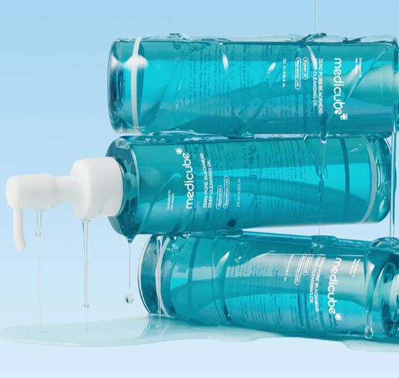 Three bottles of Medicube skincare product on a light blue background