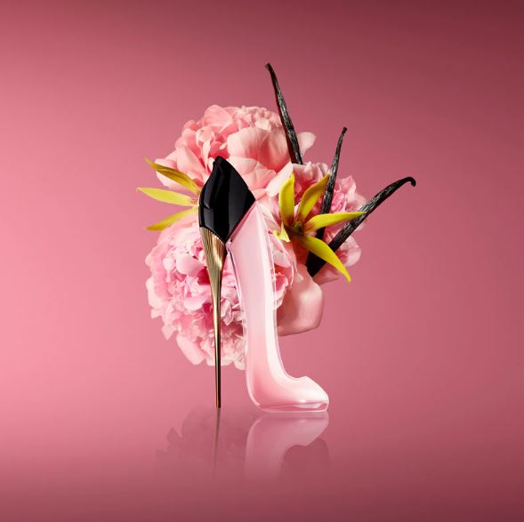 Pink high-heeled shoes with floral design on a pink background