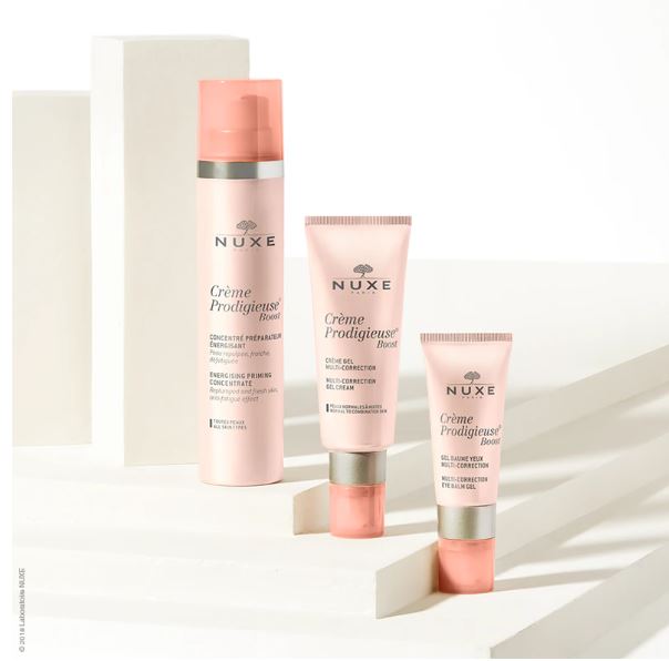 Nuxe skincare products including a bottle and two tubes on a white background