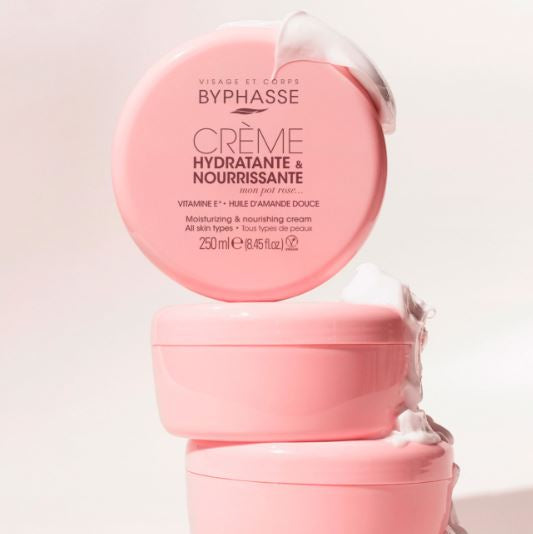 Pink Byphasse cream jar with a white lid on a light pink background