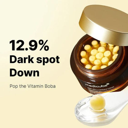 Jar of Vitamin Boba cream with text claiming 12.9% dark spot reduction on a beige background.