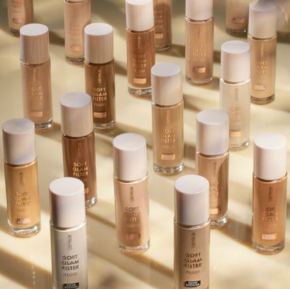 Multiple bottles of a cosmetic product with white caps on a reflective surface.