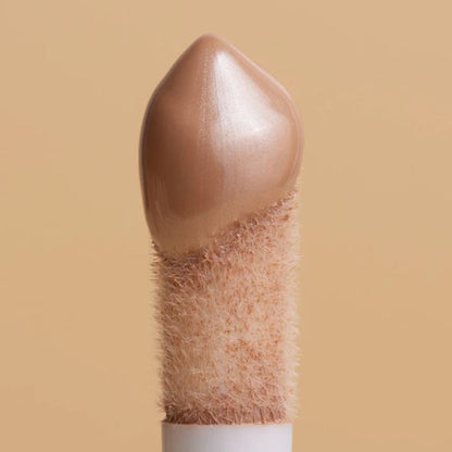 Beige hairbrush with bristles on a beige background