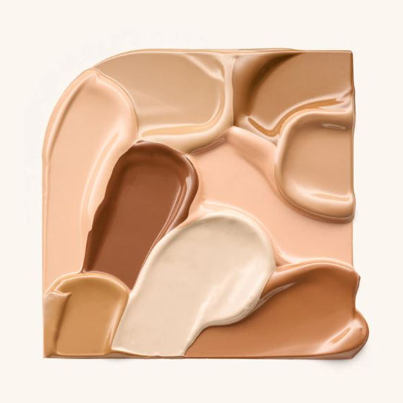 Makeup palette with beige, brown, and white shades on a light background