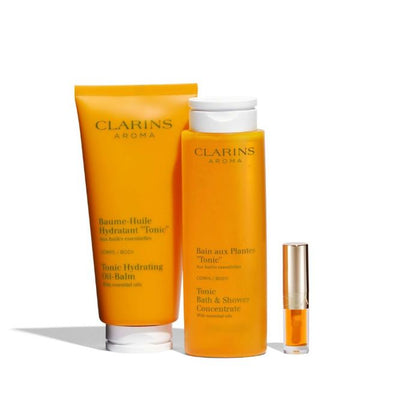 Clarins skincare products including a tube, bottle, and small container on a white background