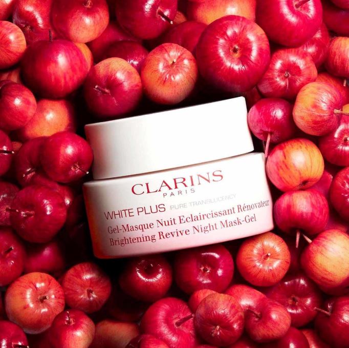 Clarins White Plus cream surrounded by red apples