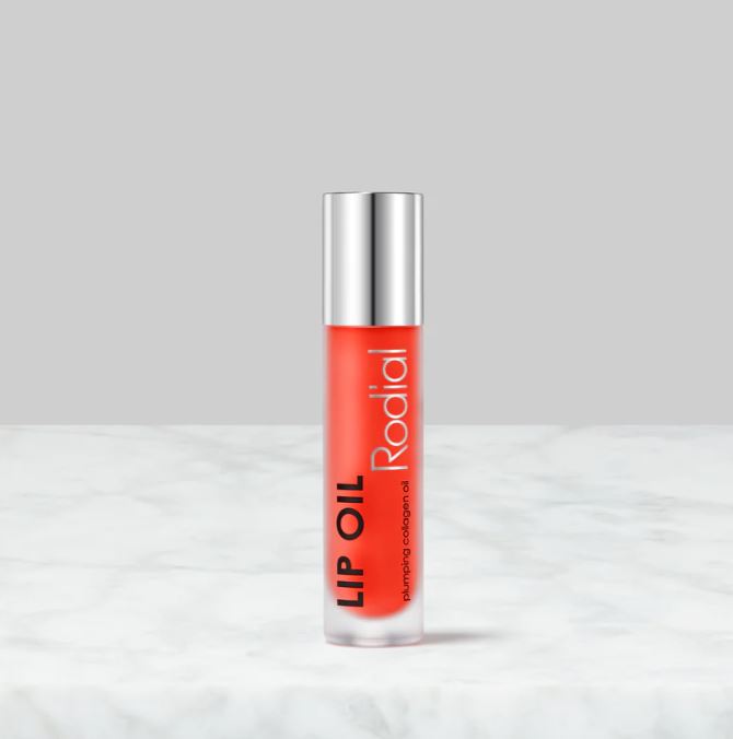 Lip oil with silver cap and red label on a white background