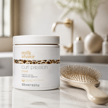 Milk Shake Curl Passion mask jar on a bathroom counter with a brush