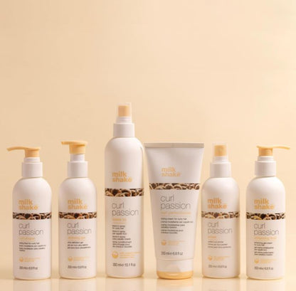 Collection of Milk Shake Curl Passion hair care products on a beige background