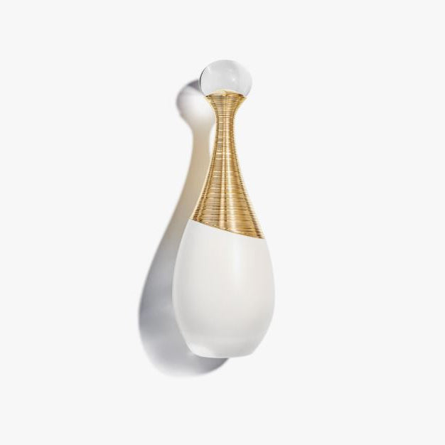 Decorative wall light fixture with white and gold design on a white background