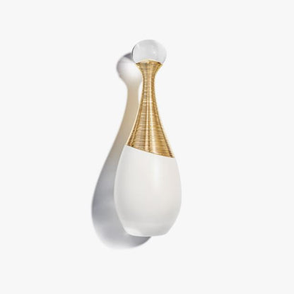 Decorative wall light fixture with white and gold design on a white background