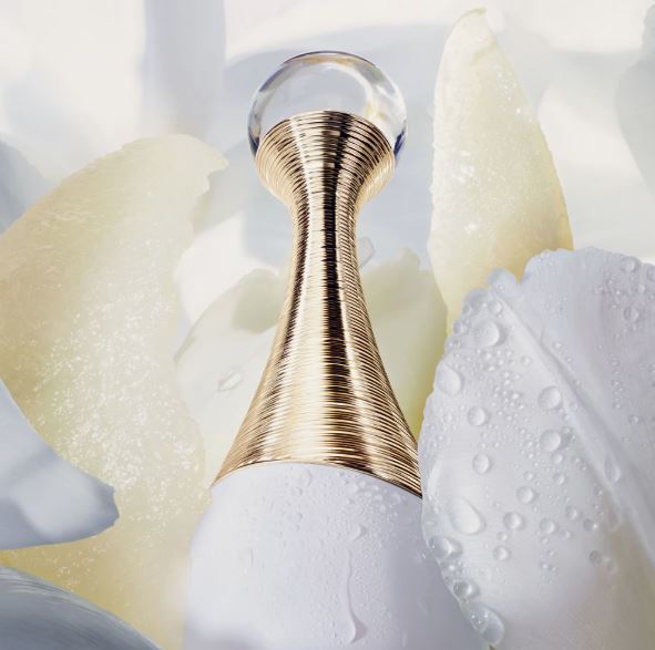 Gold bottle cap on a white background with water droplets