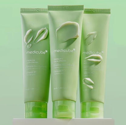 Three green tubes of Medicube cream on a light green background