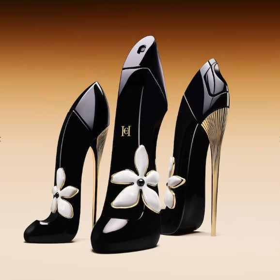 Black high-heeled shoes with white floral designs on a beige background