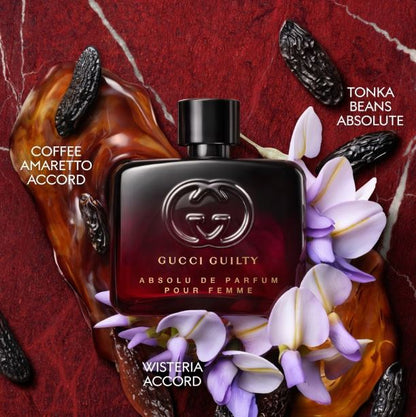 Gucci Guilty perfume bottle with flowers and coffee beans on a red background