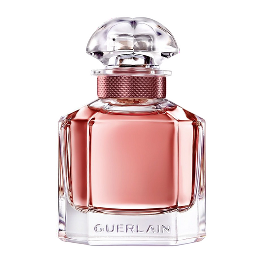 Pink Guerlain perfume bottle on a white background