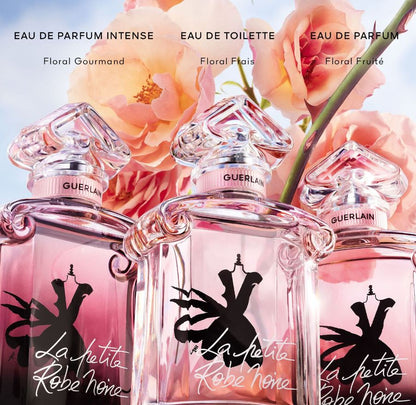 Three Guerlain perfume bottles with floral design and text on a background of pink flowers.