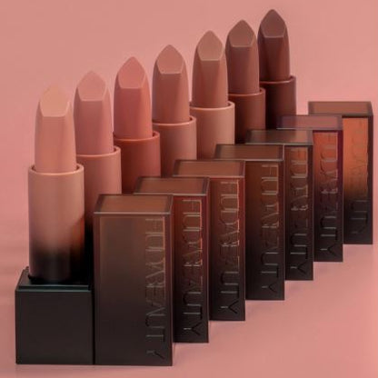 Set of lipsticks and their boxes on a pink background