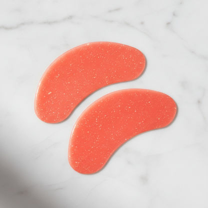 Rodial Dragon's Blood Hydrating Eye Patches in salmon coral pink gel on light background