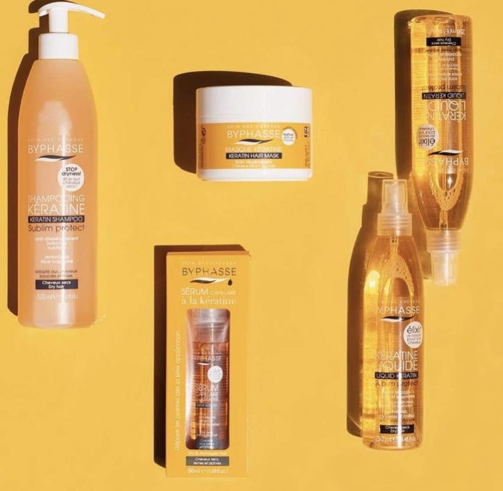 Collection of Byphasse hair care products on a yellow background