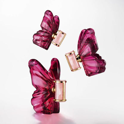 Pink butterfly-shaped perfume bottles with gold accents on a white background