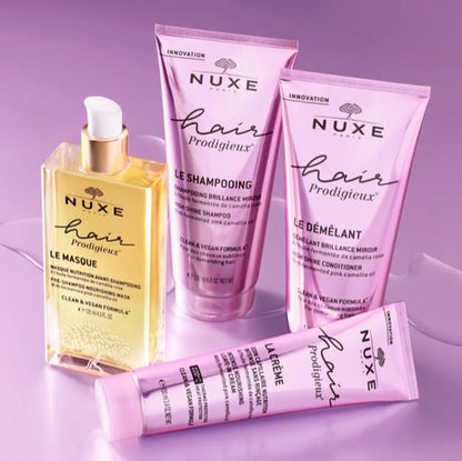 Nuxe hair care products on a purple background
