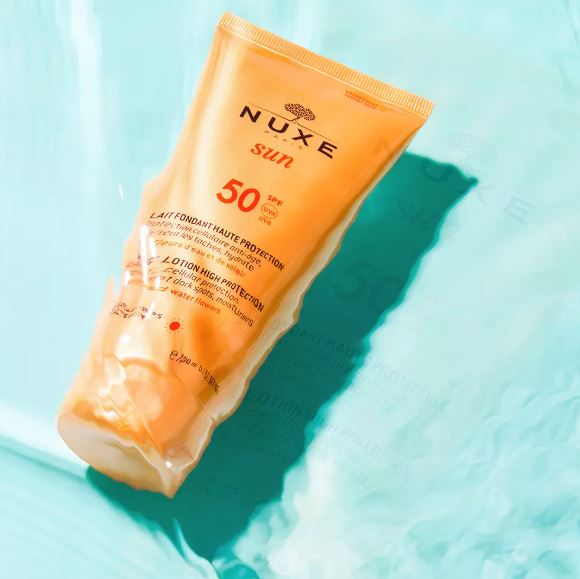 Nuxe sun lotion SPF 50 on a light blue background