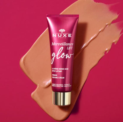Nuxe Merveillance Lift Glow skincare cream tube on a pink background