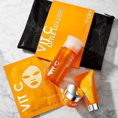 Radiant skincare product set with orange packaging on a marble surface