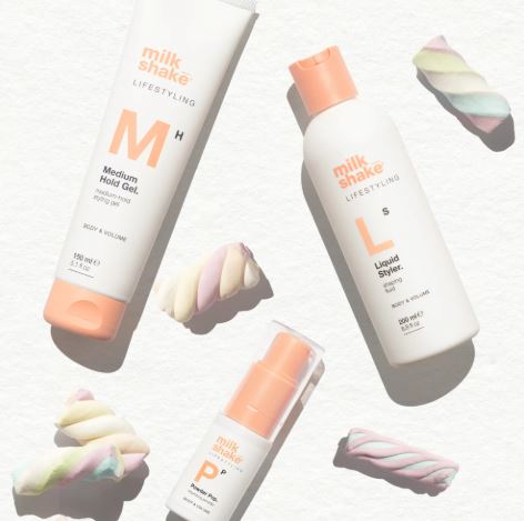 Three bottles of Milk Shake hair products on a white background with colorful hair swatches.