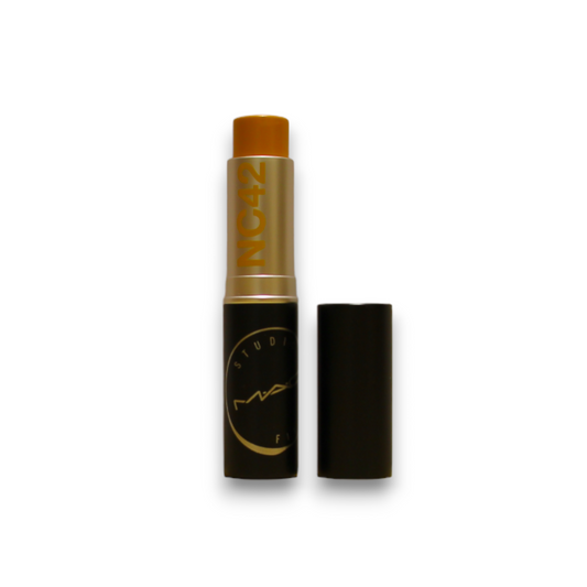 Makeup stick with black and gold packaging on a white background