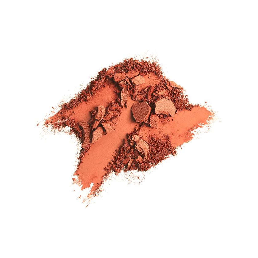 Pile of crushed orange makeup powder on a white background