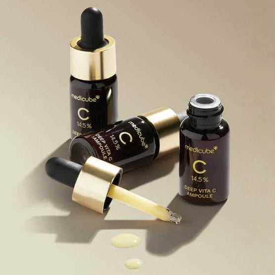 Medicube Deep Vita C Ampoule bottles on a beige background