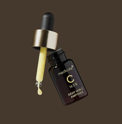 Medicube Deep VITA C Ampoule dropper with yellow liquid on a dark background