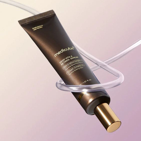 Medicube skincare product on a clear stand with a soft pink background