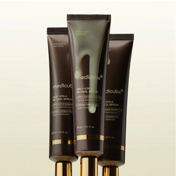Three tubes of Medicube Deep Vita A Retinol Serum on a beige background