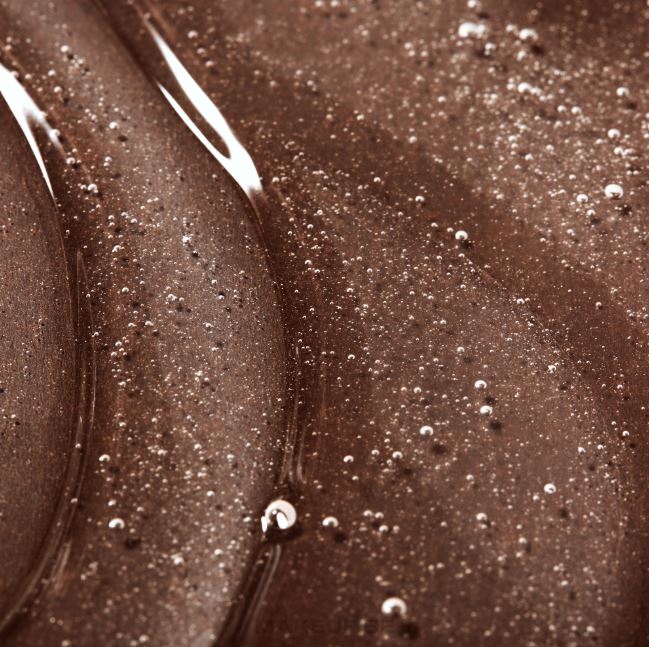 Close-up of a brown, creamy substance with bubbles