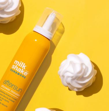 Shower mousse bottle with whipped cream on a yellow background
