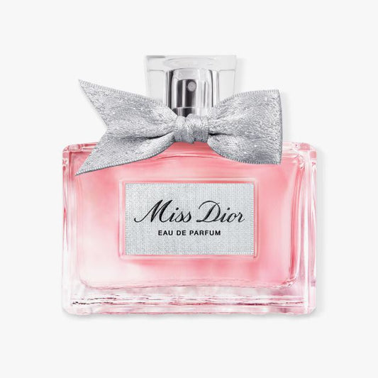 Miss Dior Eau de Parfum bottle with a silver bow on a white background