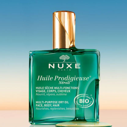 Nuxe Huile Prodigieuse bottle on a gradient background